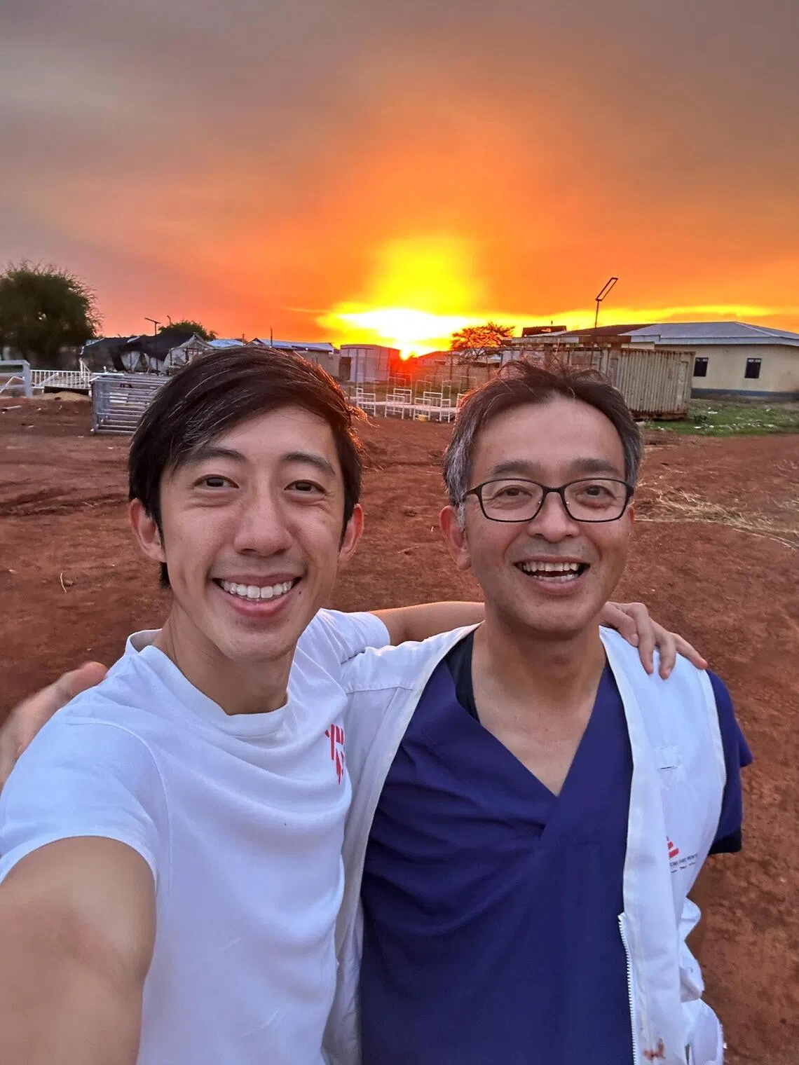 Tan Tock Seng Hospital specialist trauma surgeon Tang Jun Han with Japanese general surgeon Mikio Shiozawa in Abyei.