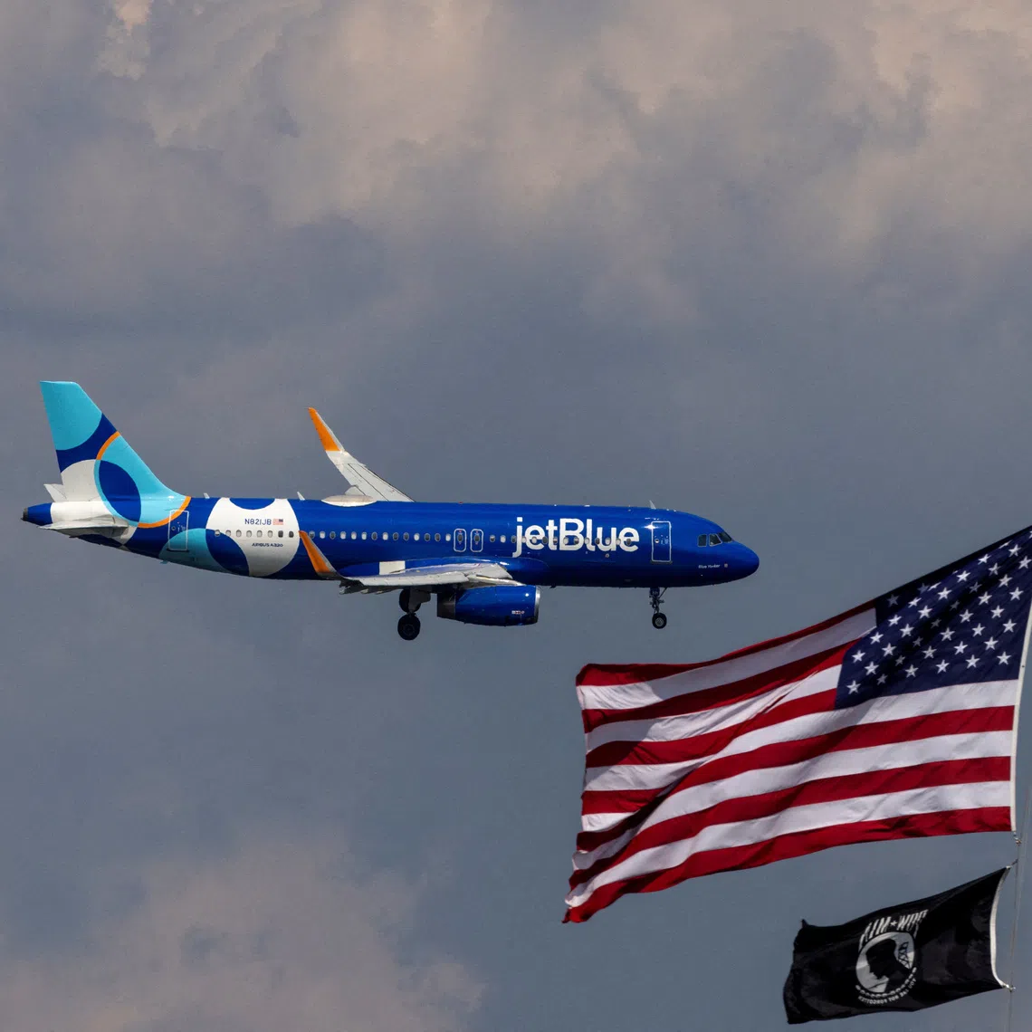 FILE PHOTO: A JetBlue Airlines commercial aircraft flies over Washington as it approaches to land at Dulles International Airport, as seen from Washington, U.S., August 5, 2024. REUTERS/ Umit Bektas/File Photo