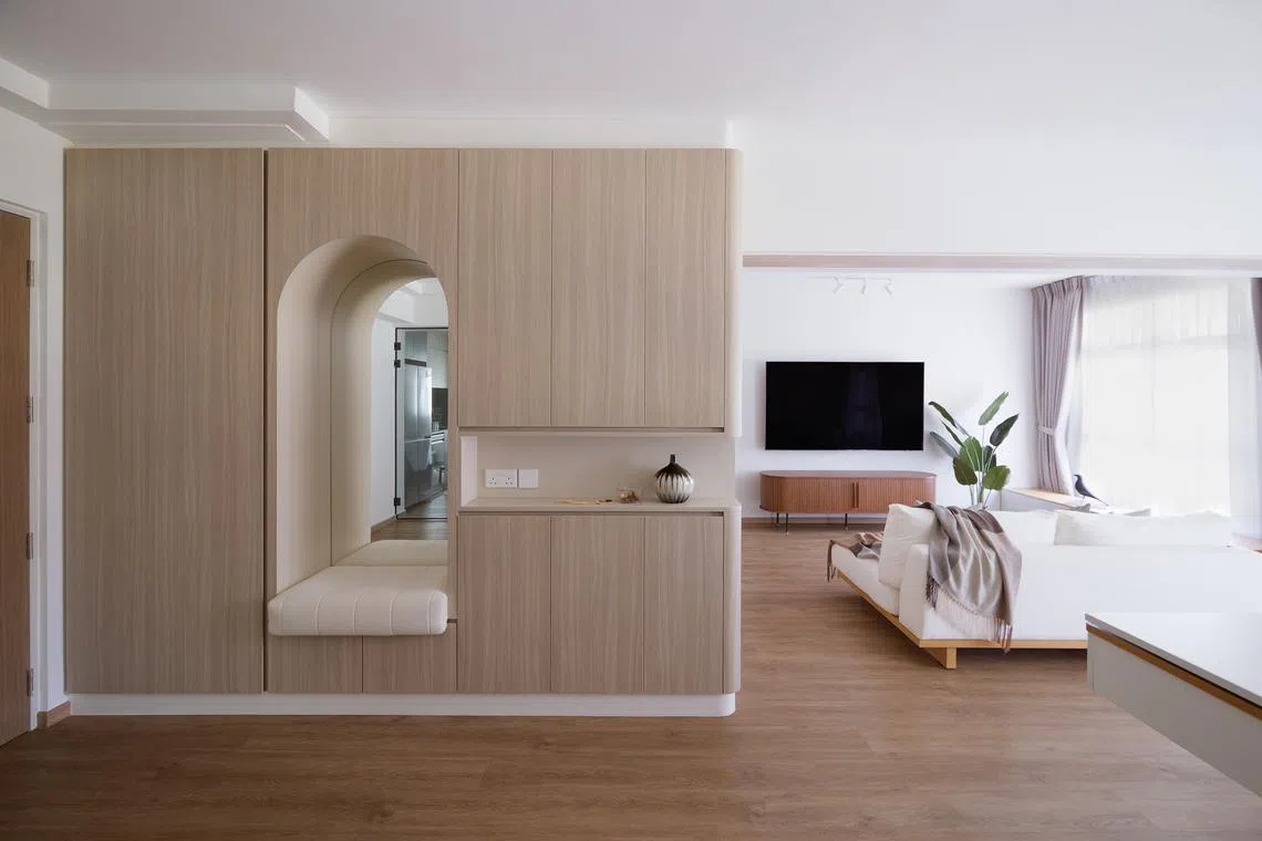 Floor-to-ceiling carpentry screens off the interior of this HDB flat, giving its owners privacy.