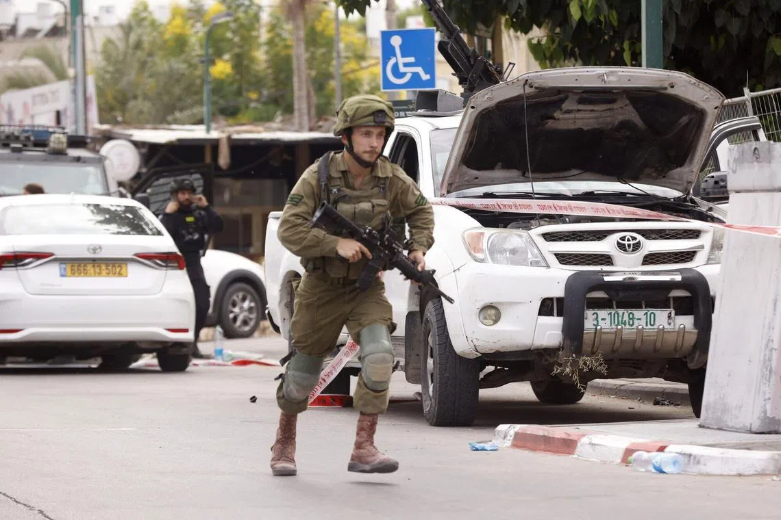 An Israeli soldier near a police station occupied by Hamas soldiers, in Sderot, Israel.