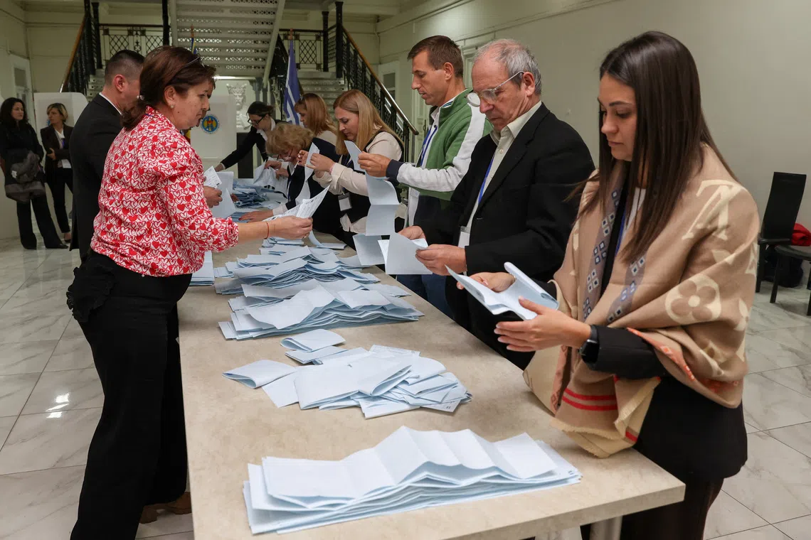 Members of an electoral commission count ballots after polling stations closed in Moldova's parliamentary elections in Chisinau, Moldova September 28, 2025.  REUTERS/Stringer