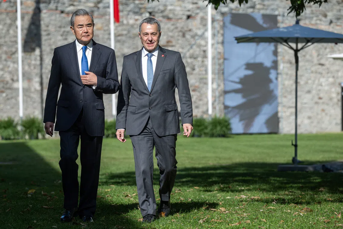 China's Foreign Minister Wang Yi and Swiss Foreign Minister Ignazio Cassis walk during an official visit at Castelgrande in Bellinzona, Switzerland, October 10, 2025. ELIA BIANCHI/Pool via REUTERS