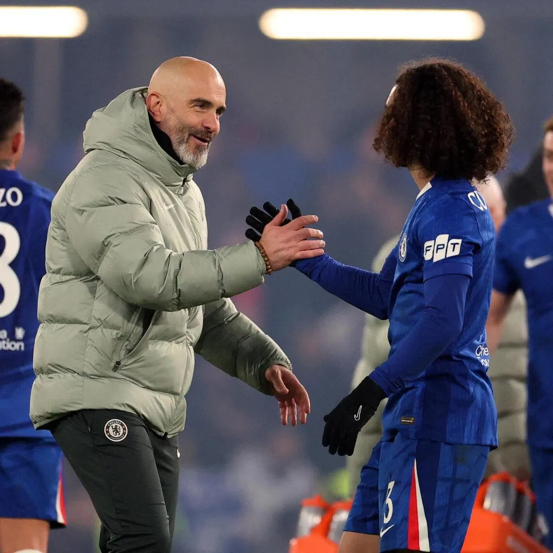 Chelsea manager Enzo Maresca shaking hands with Marc Cucurella after the match.