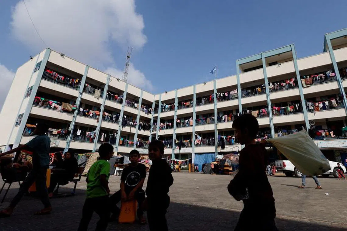 Palestinians, who have fled their homes due to Israeli strikes, take shelter in a UN-run school, in Khan Younis in the southern Gaza Strip, October 23, 2023.  REUTERS/Mohammed Salem/File Photo