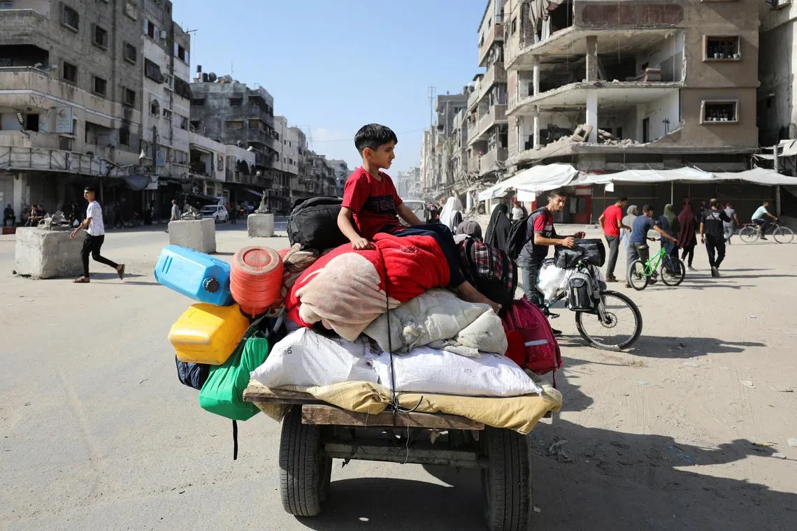 A displaced Palestinian boy sits on a cart as he and others make their way to flee areas in the northern Gaza Strip, following an Israeli evacuation order, amid the Israel-Hamas conflict, in Gaza City October 12, 2024. REUTERS/Dawoud Abu Alkas