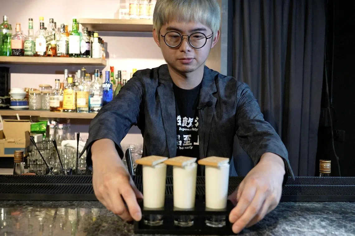 Powei Lee, 31, owner of Kinmen Mojo Bar (or Vent Bar), displays for the camera the "Pick and Eat" cocktail, in Kinmen Island, Taiwan, May 25, 2024. REUTERS/Joyce Zhou