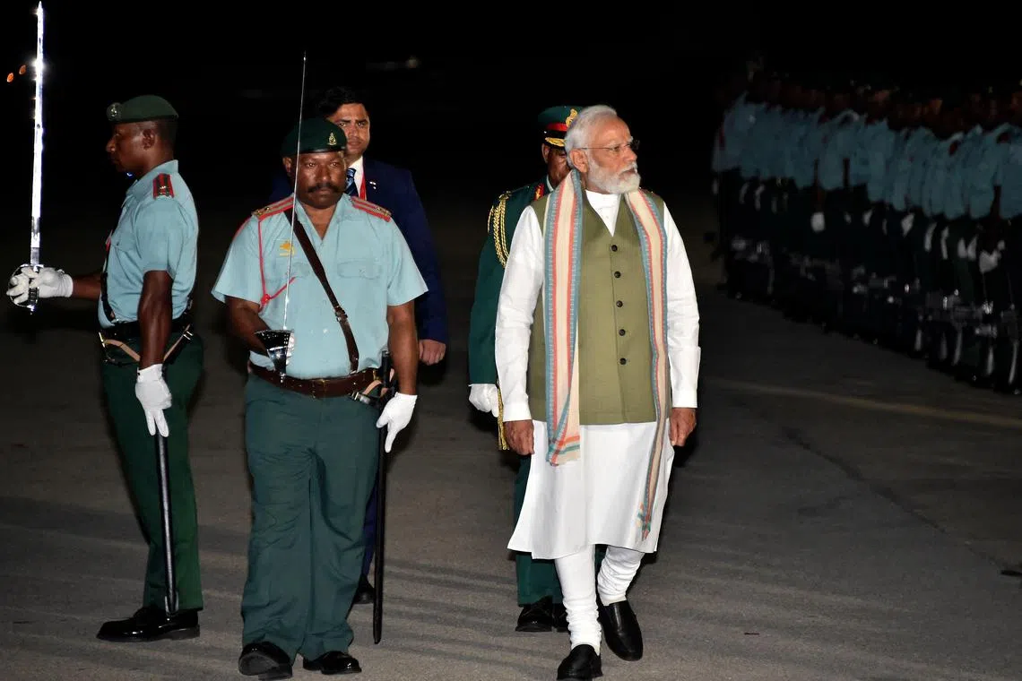 India's Prime Minister Narendra Modi (right) inspects the guard of honour upon his arrival at Port Moresby International Airport in Papua New Guinea on Sunday.