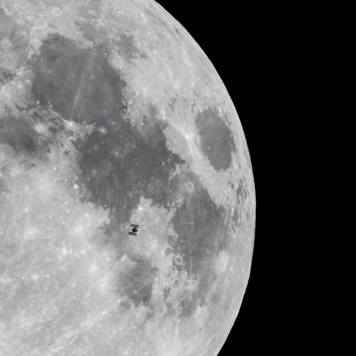 Nasa's International Space Station, orbiting the Earth, is captured against a backdrop of the Moon from Szurdokpuspoki, northern Hungary, on Nov 4, 2025.