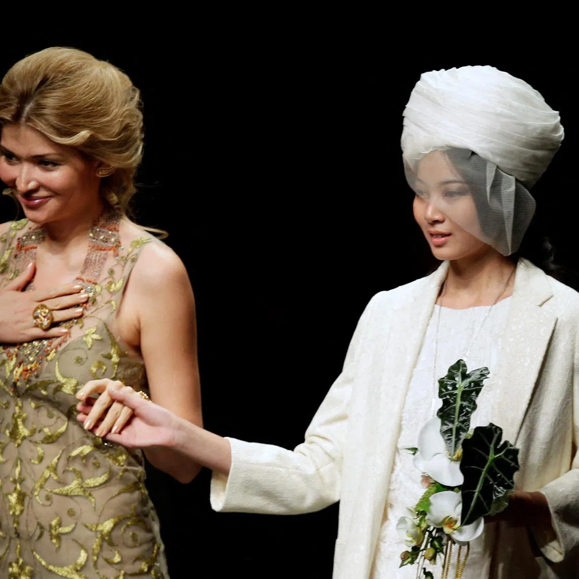 FILE PHOTO: Designer Gulnara Karimova (L), daughter of Uzbekistan's President Islam Karimov, stands with a model after presenting her Guli Collection at China Fashion Week in Beijing October 30, 2012. REUTERS/Jason Lee/File Photo