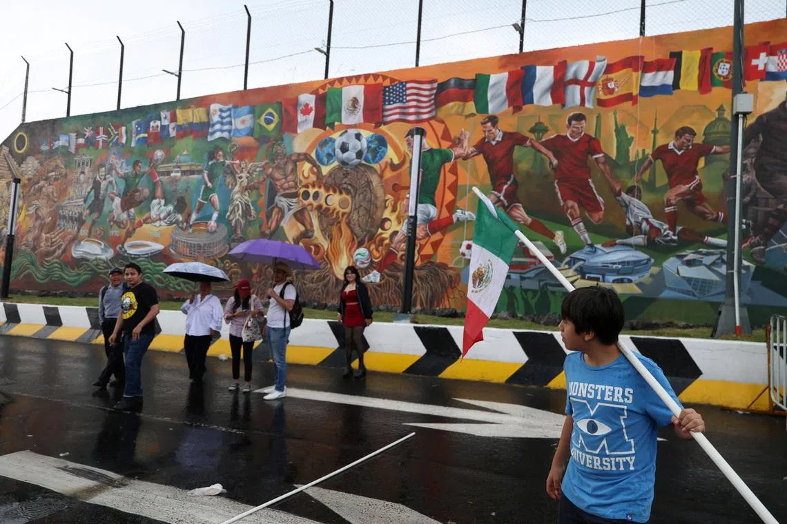 People walk in front of a football-themed mural spanning more than 200 square meters, which aims to break a Guinness World Record before the 2026 World Cup, in Mexico City, Mexico, May 24, 2026. REUTERS/Luis Cortes