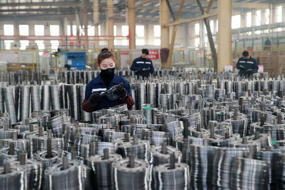 employees working on aluminum products at a factory in Huaibei, China, on Jan 30, 2023.