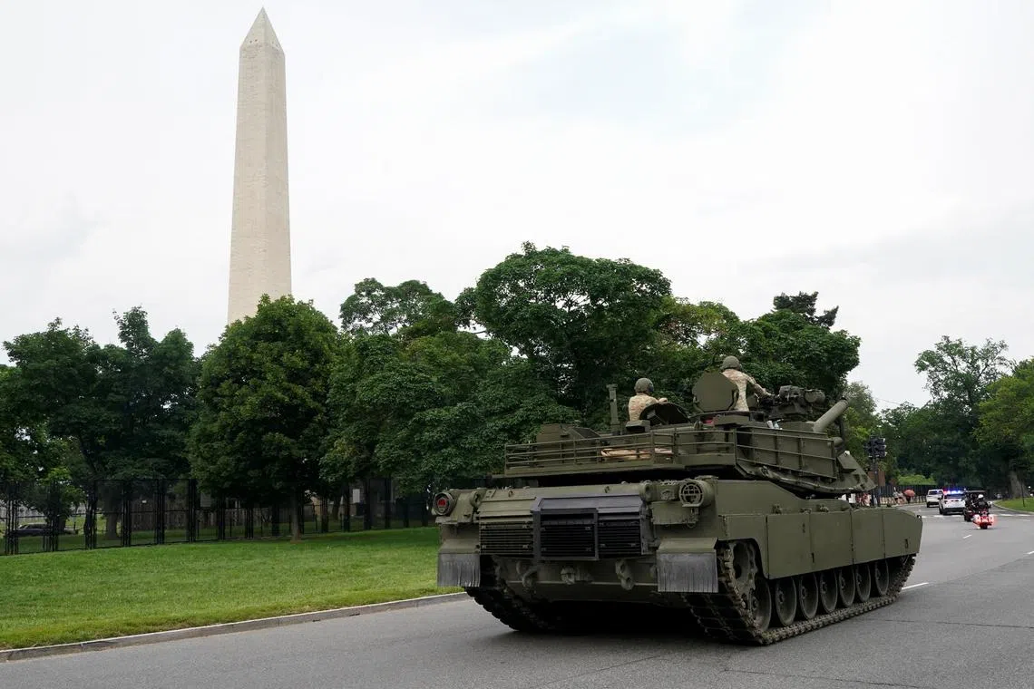 FILE PHOTO: Members of the U.S Army sit atop an M1A2 Abrams tank near the Washington Monument in Washington, D.C., U.S., June 13, 2025. REUTERS/Nathan Howard/File Photo