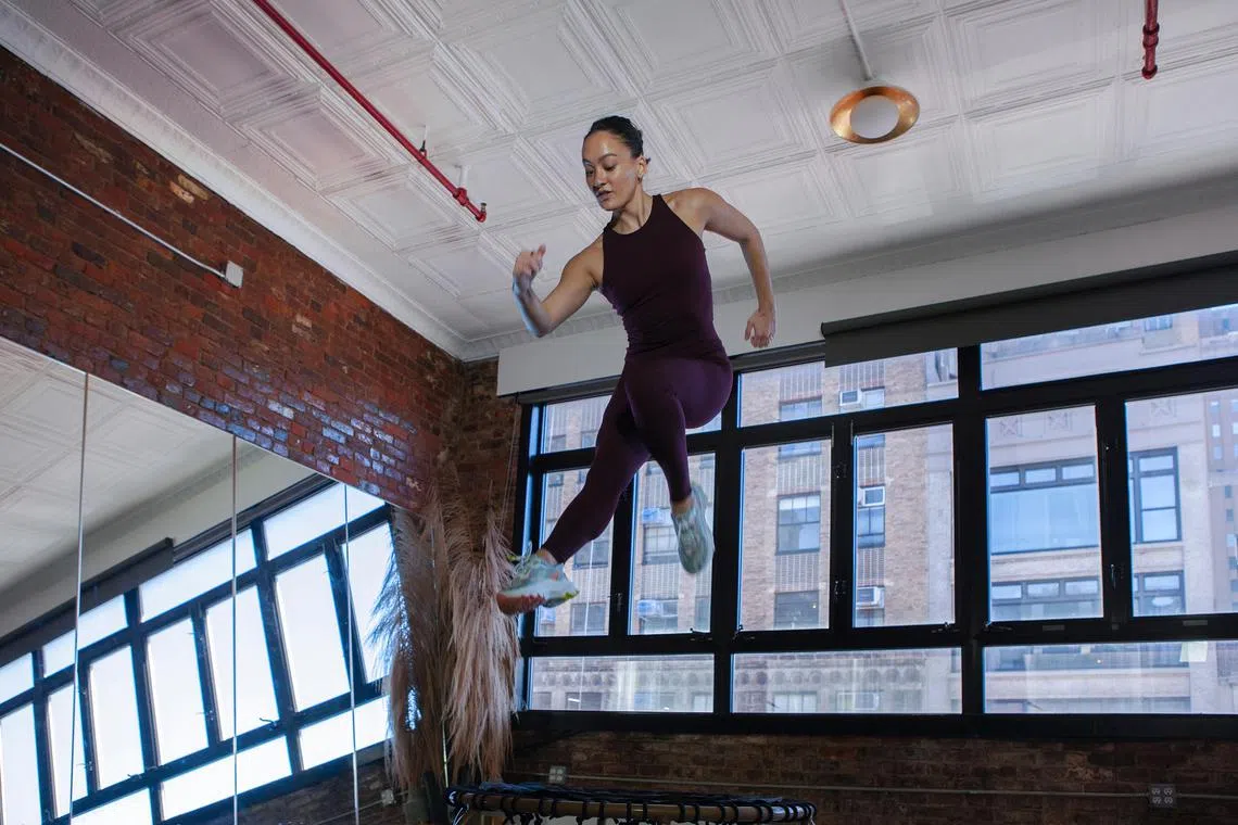Colette Dong, co-founder of a New York bouncing studio called The Ness, does a trampoline workout at the studio on Oct 27, 2022. 