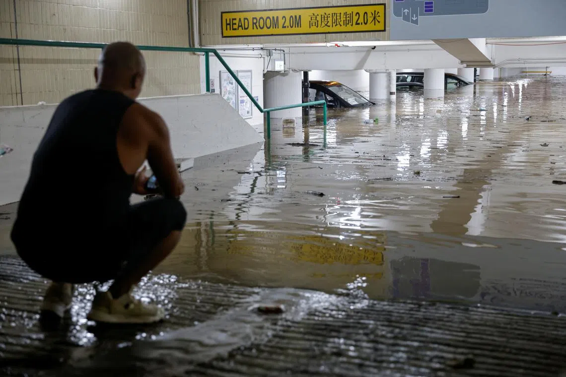 Vehicles are seen at a flooded car park during heavy rain, in Hong Kong, China, Sept 8, 2023. 