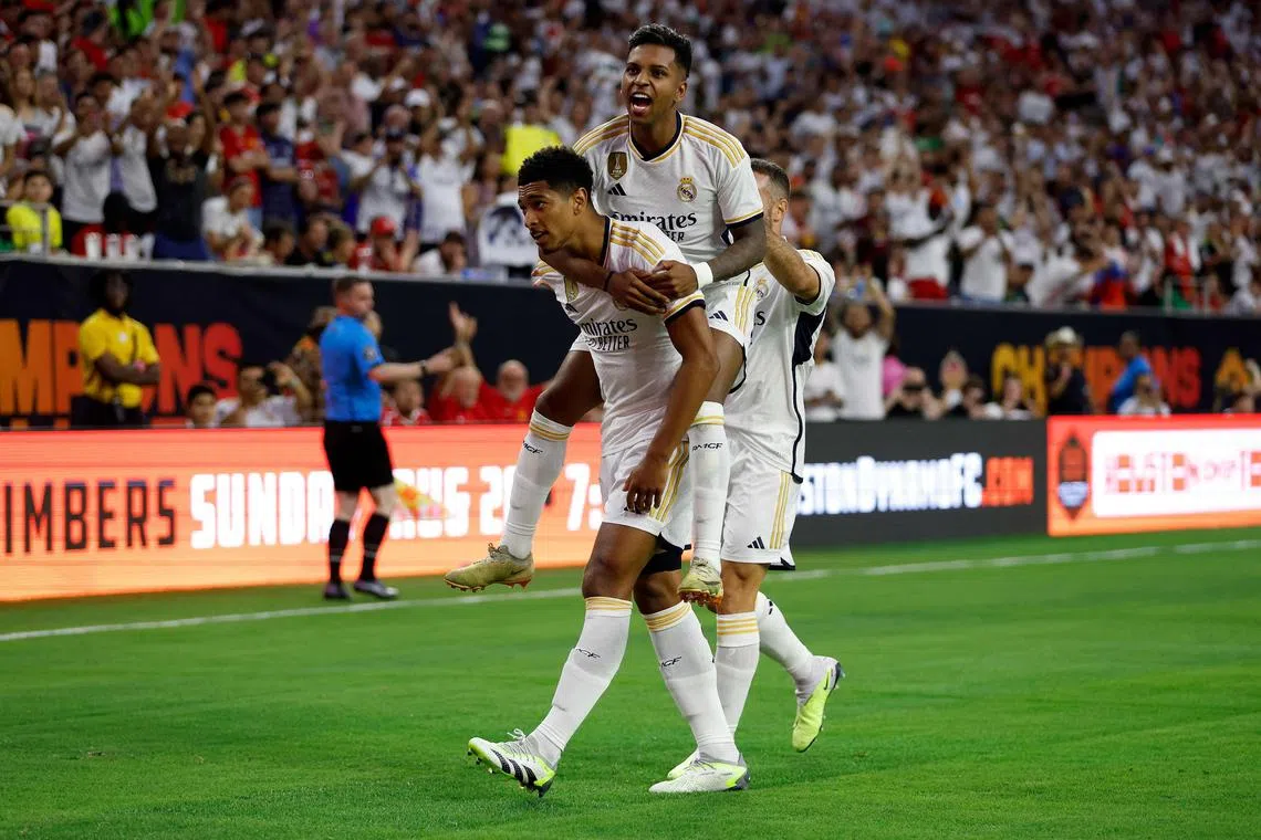 Rodrygo of Real Madrid celebrating with Jude Bellingham (left) after a goal in the first half against Manchester United during the 2023 Soccer Champions Tour match at NRG Stadium on Tuesday in Houston, Texas.  Real won 2-0.