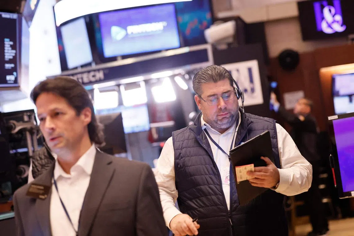 Traders work on the floor of the New York Stock exchange, in New York City.