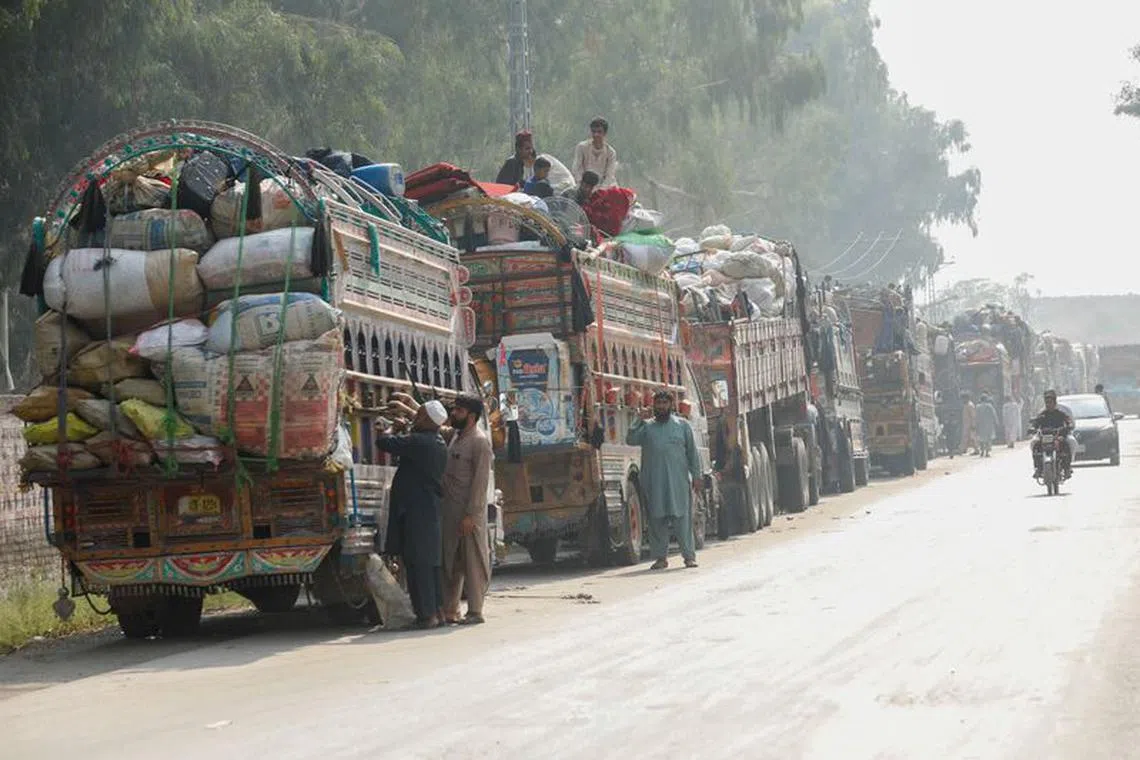 FILE PHOTO: Trucks loaded with belongings are seen as Afghan refugees are returning home, after Pakistan gives the last warning to undocumented immigrants to leave, outside the United Nations High Commissioner for Refugees (UNHCR) repatriation centres in Azakhel town in Nowshera, Pakistan October 30, 2023. REUTERS/Fayaz Aziz/File photo