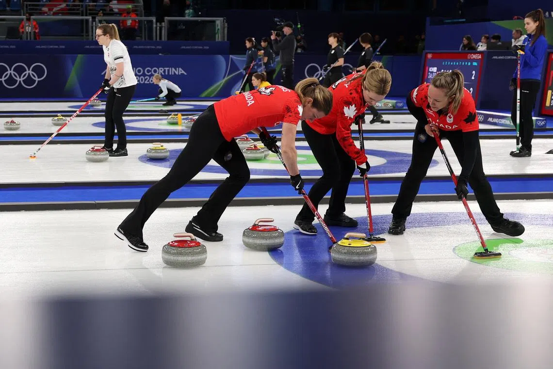 Milano Cortina 2026 Olympics - Curling - Women's Round Robin Session 1 - Canada vs Denmark - Cortina Curling Olympic Stadium, Cortina d'Ampezzo, Italy - February 12, 2026. Rachel Homan of Canada, Sarah Wilkes of Canada and Tracy Fleury of Canada during their match against Denmark in Women's Round Robin Session 1. REUTERS/Issei Kato