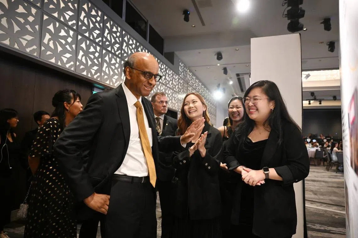 Halogen Foundation youths and staff (from left) Tay Zee Hsien, Chew Hui, and Rozanne Goh, give presidential hopeful Mr Tharman Shanmugaratnam a tour of the exhibition at The Halogen Ball at Hilton Singapore Orchard on August 17, 2023. 

(ST PHOTO: AZMI ATHNI)