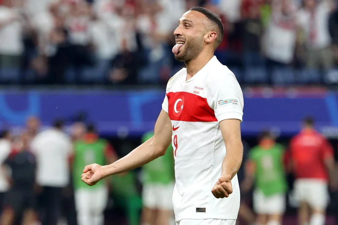 Turkey's Cenk Tosun celebrates after scoring his team's second, winning goal.