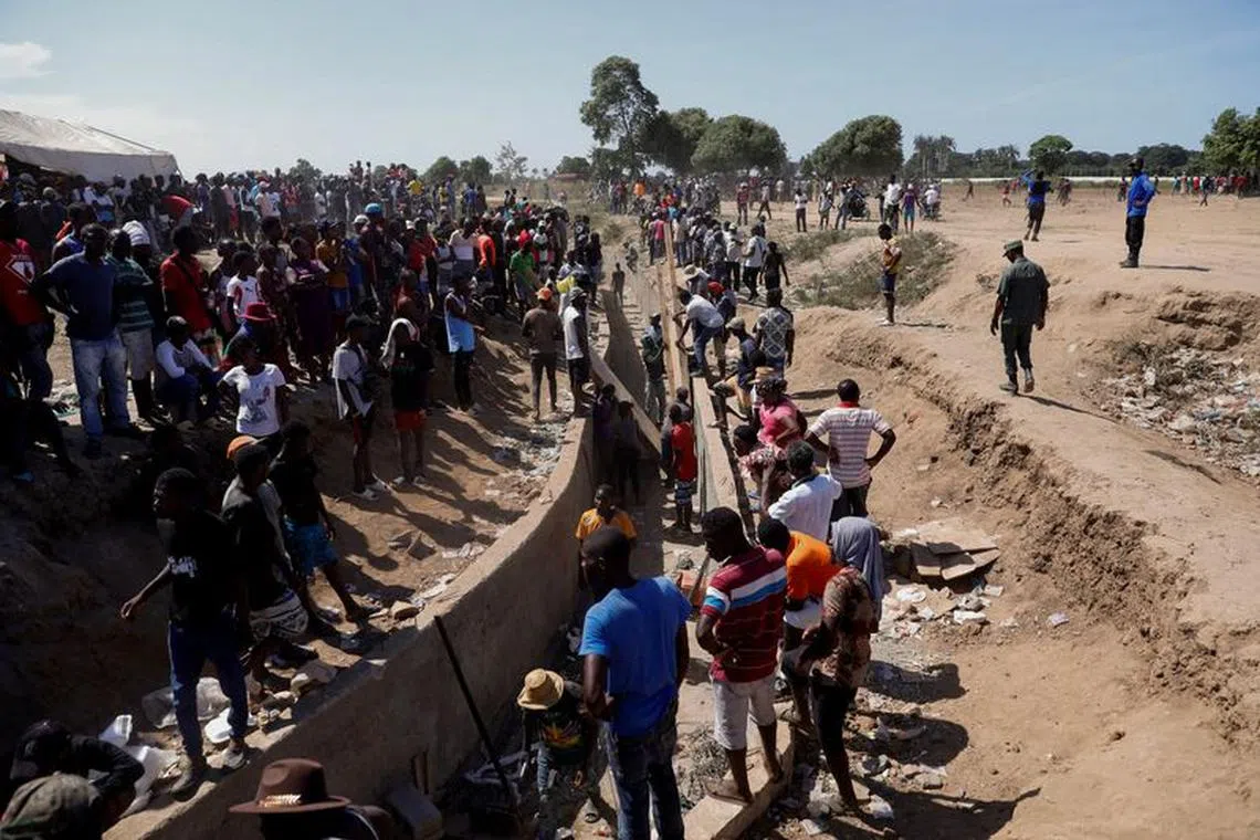 FILE PHOTO: Haitians work on the construction site of a water channel from the Massacre river, a river shared between Haiti and the Dominican Republic, after Dominican President Luis Abinader announced a total border shutdown amid a conflict over the construction of the channel, in Ouanaminthe, Haiti September 15, 2023. REUTERS/Octavio Jones/File Photo