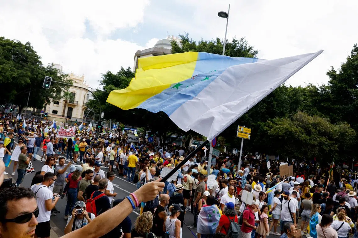 People protesting in Santa Cruz de Tenerife, on April 20, 2024. Residents of the Canary Islands say a boom in short-term holiday rentals and hotel construction is driving up housing costs for locals.