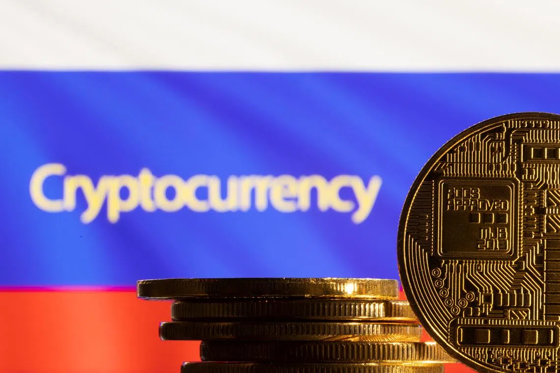 A representation of the cryptocurrency is seen in front of word \"Cryptocurrency\" and Russian flag in this illustration taken, March 4, 2022. REUTERS/Dado Ruvic/Illustration
