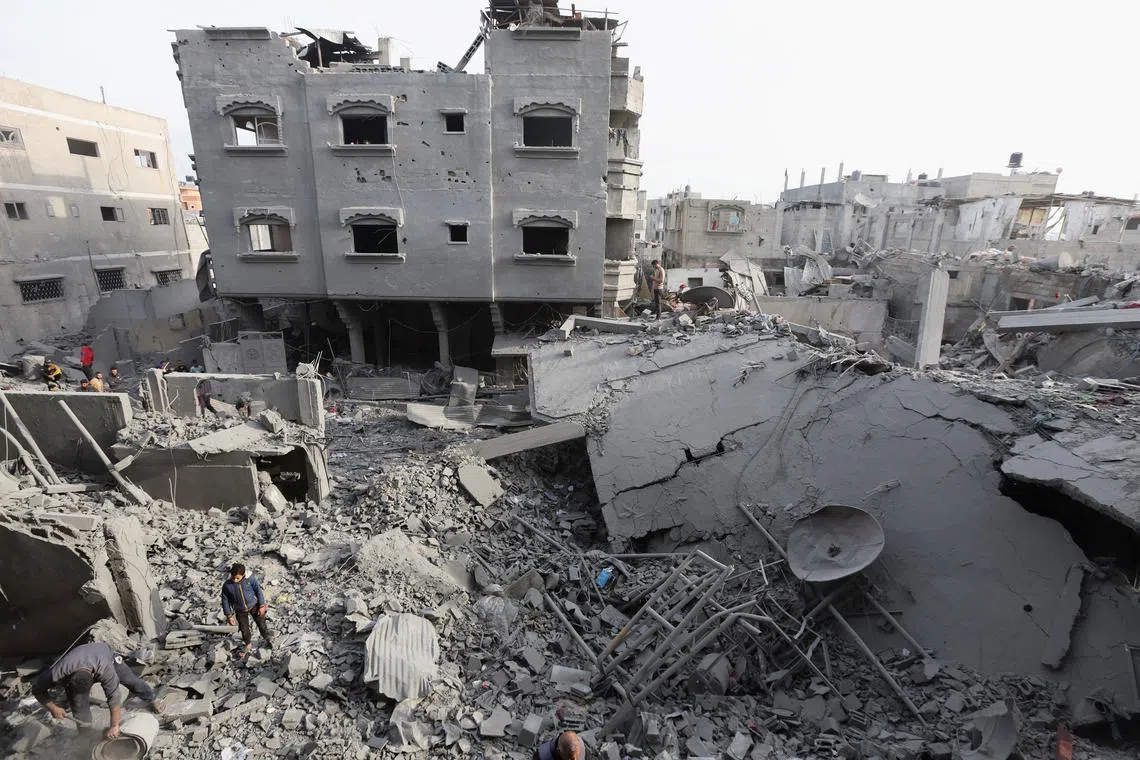 FILE PHOTO: Palestinians inspect damage at the site of an Israeli strike on a house, amid the Israel-Hamas conflict, at the Nuseirat refugee camp in the central Gaza Strip, December 7, 2024. REUTERS/Ramadan Abed/File photo