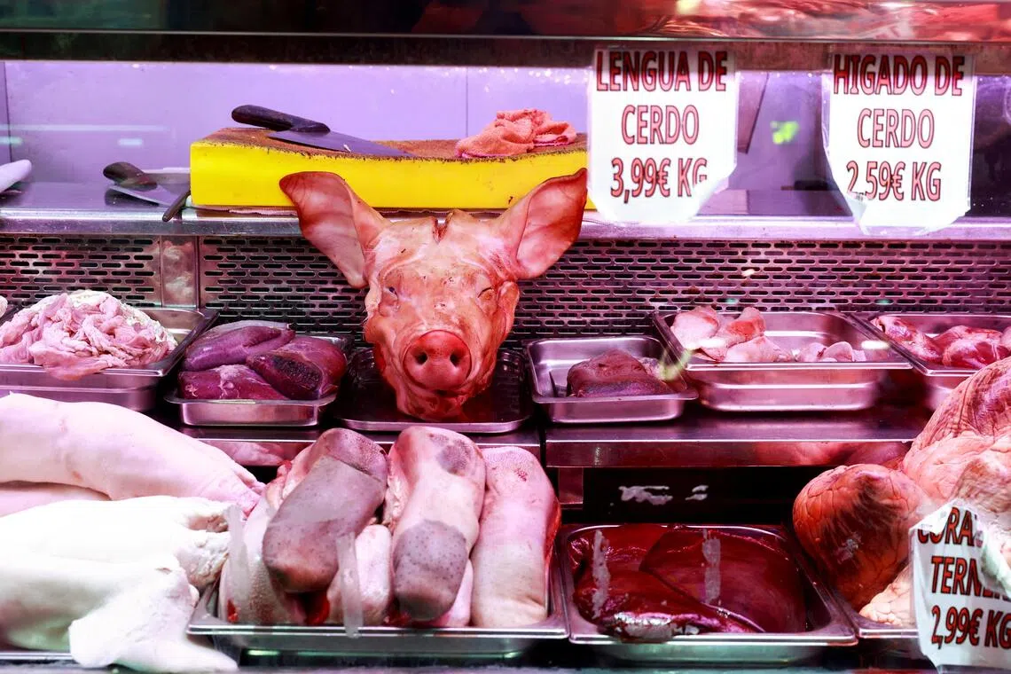 A 2024 photo shows pork products displayed at a market stall in Madrid, Spain.