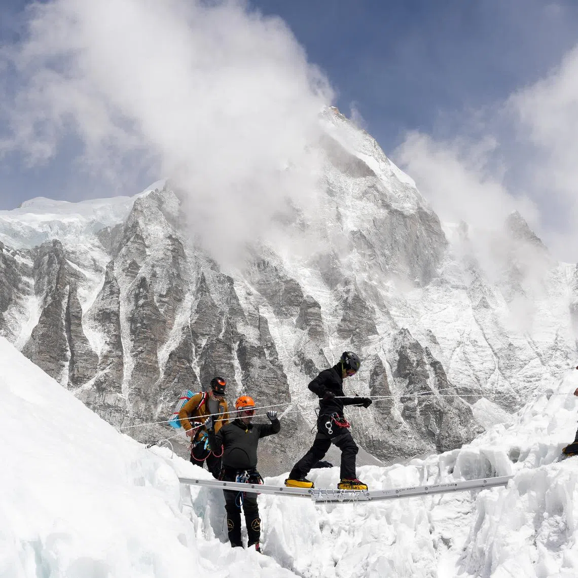 FILE PHOTO: Mountaineers practice walking on a ladder during a training session at Everest base camp, Nepal April 15, 2025. REUTERS/Purnima Shrestha/File Photo
