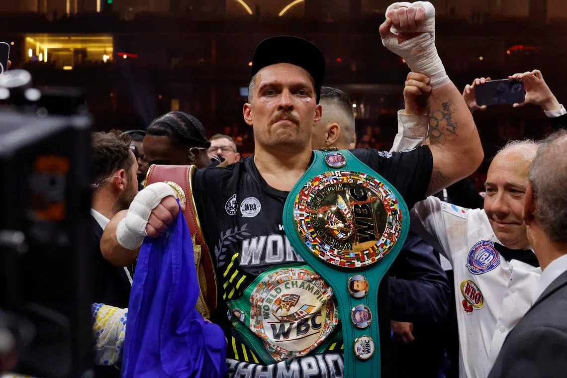 FILE PHOTO: Boxing - Tyson Fury v Oleksandr Usyk - Kingdom Arena, Riyadh, Saudi Arabia - May 19, 2024 Oleksandr Usyk celebrates with the belts after winning the fight to become the undisputed heavyweight world champion Action Images via Reuters/Andrew Couldridge/File Photo
