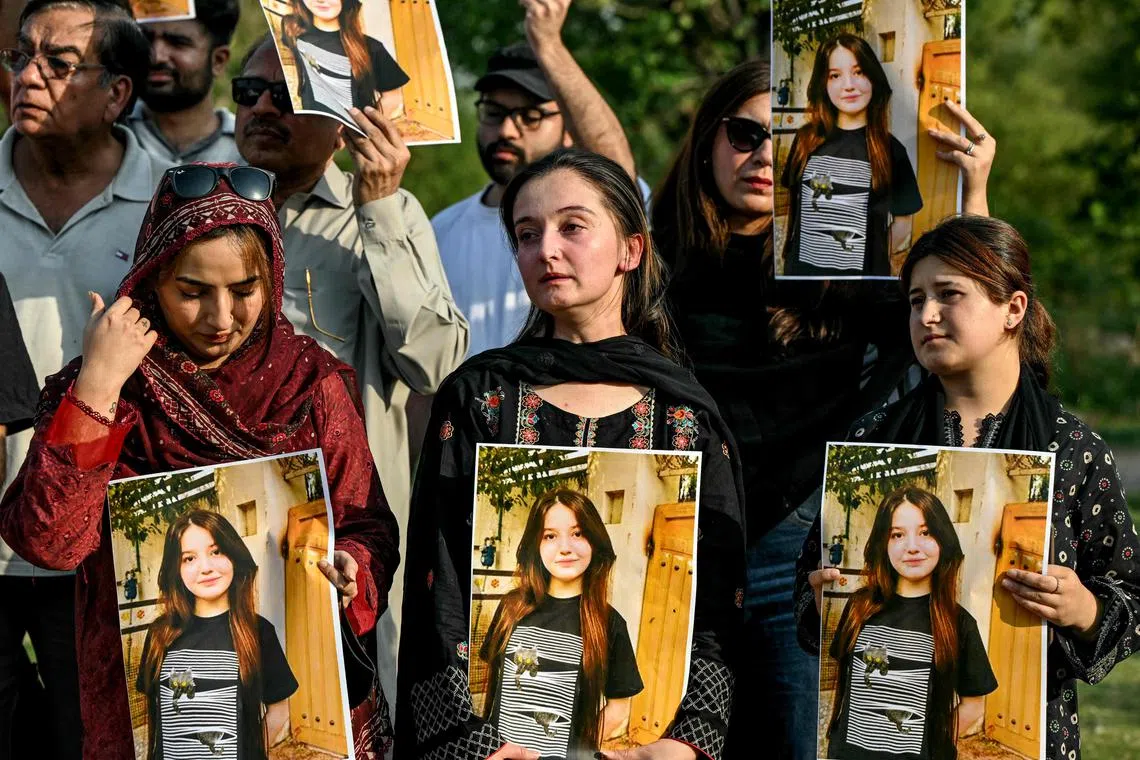 Activists holding photos of teenage TikTok star Sana Yousaf, who was murdered by a man whose advances she had repeatedly rejected, in Islamabad on June 5.