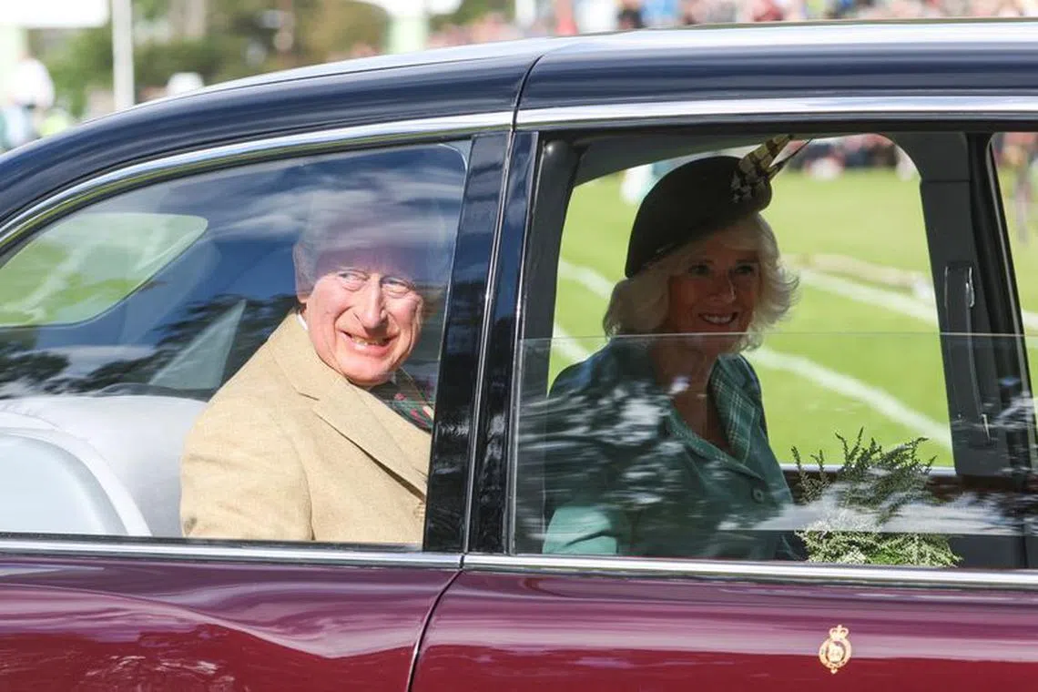 FILE PHOTO: Britain's King Charles and Queen Camilla look out of a car window at the Braemar Royal Highland Gathering at the Princess Royal and Duke of Fife Memorial Park in Braemar, Scotland, Britain September 2, 2023. REUTERS/Russell Cheyne/File Photo