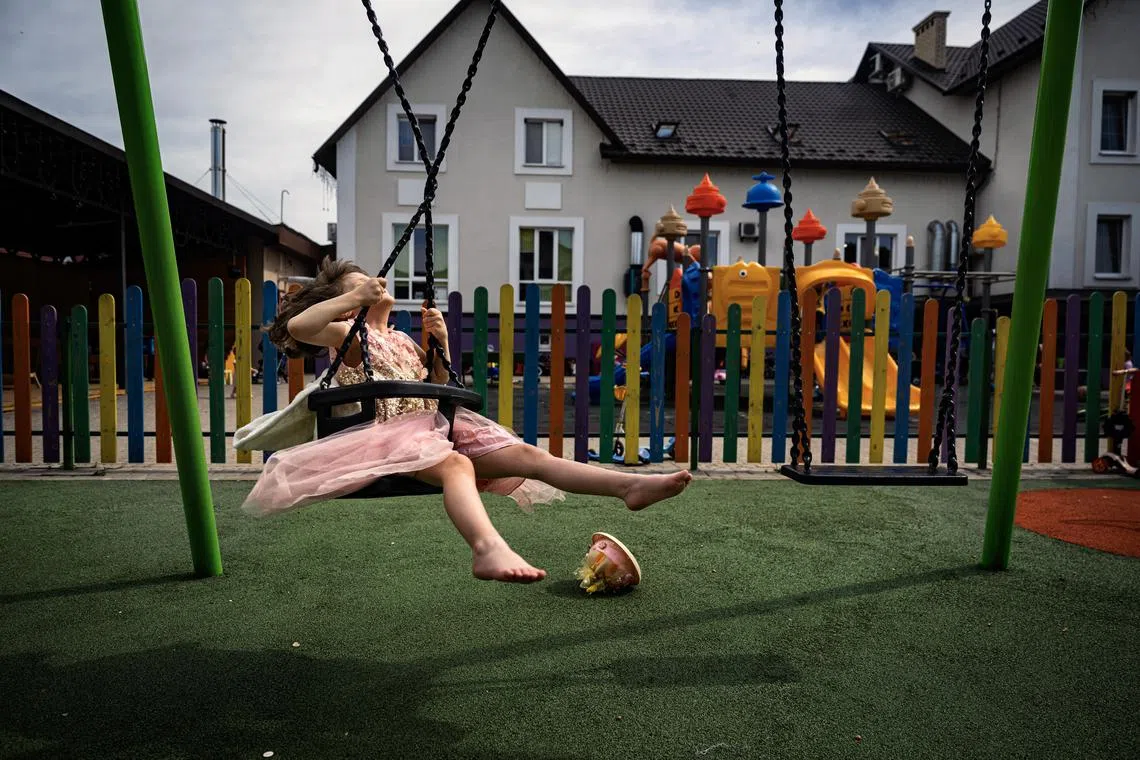 Sonya Liakh, 5, plays on a swing at the City of Goodness, a palliative care shelter in Chernivtsi, Ukraine, on June 7, 2024. RussiaÕs invasion had uprooted SonyaÕs life, as it had so many in Ukraine. It had killed her father at the front line and dealt a debilitating blow to her health, delaying her chemotherapy and allowing a rare form of cancer to rob her of her vision and ravage her body. (Lynsey Addario/The New York Times) Ñ NO SALES