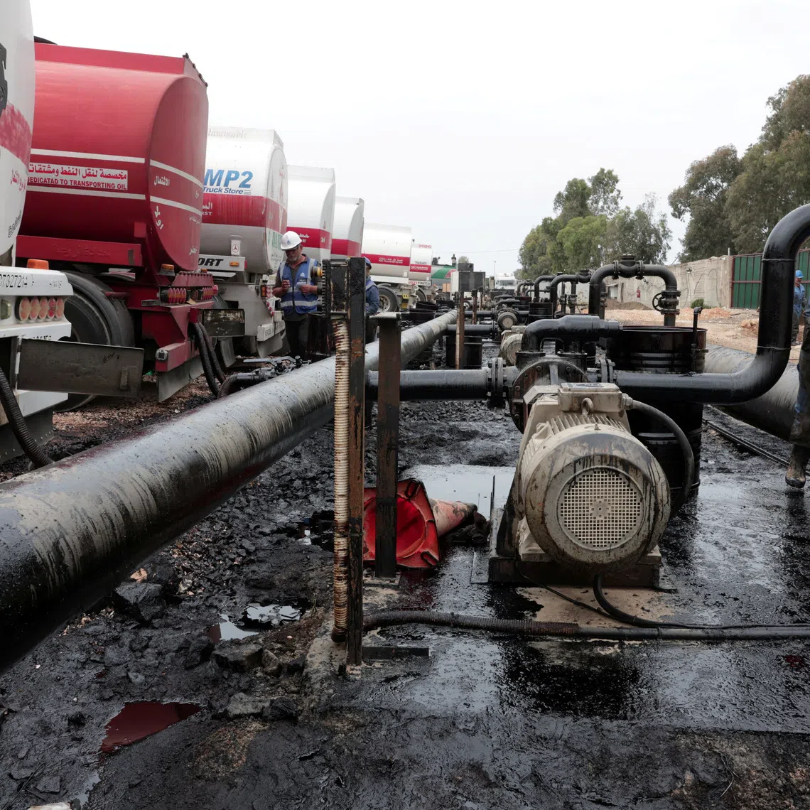 FILE PHOTO: Oil trucks arriving from Iraq at the Baniyas oil terminal, in Baniyas, Syria, May 14, 2026.  REUTERS/Mahmoud Hassano/File Photo