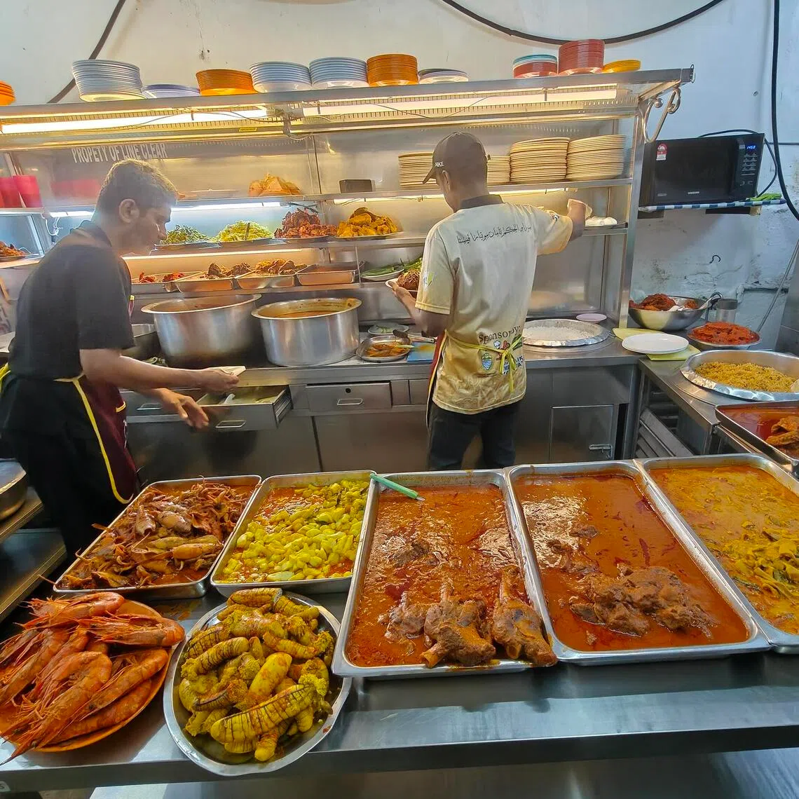 The spread at Nasi Kandar Line Clear in George Town. Nasi kandar, a Tamil Muslim fare, is one of the culinary treasures of the northern Malaysian state of Penang. 