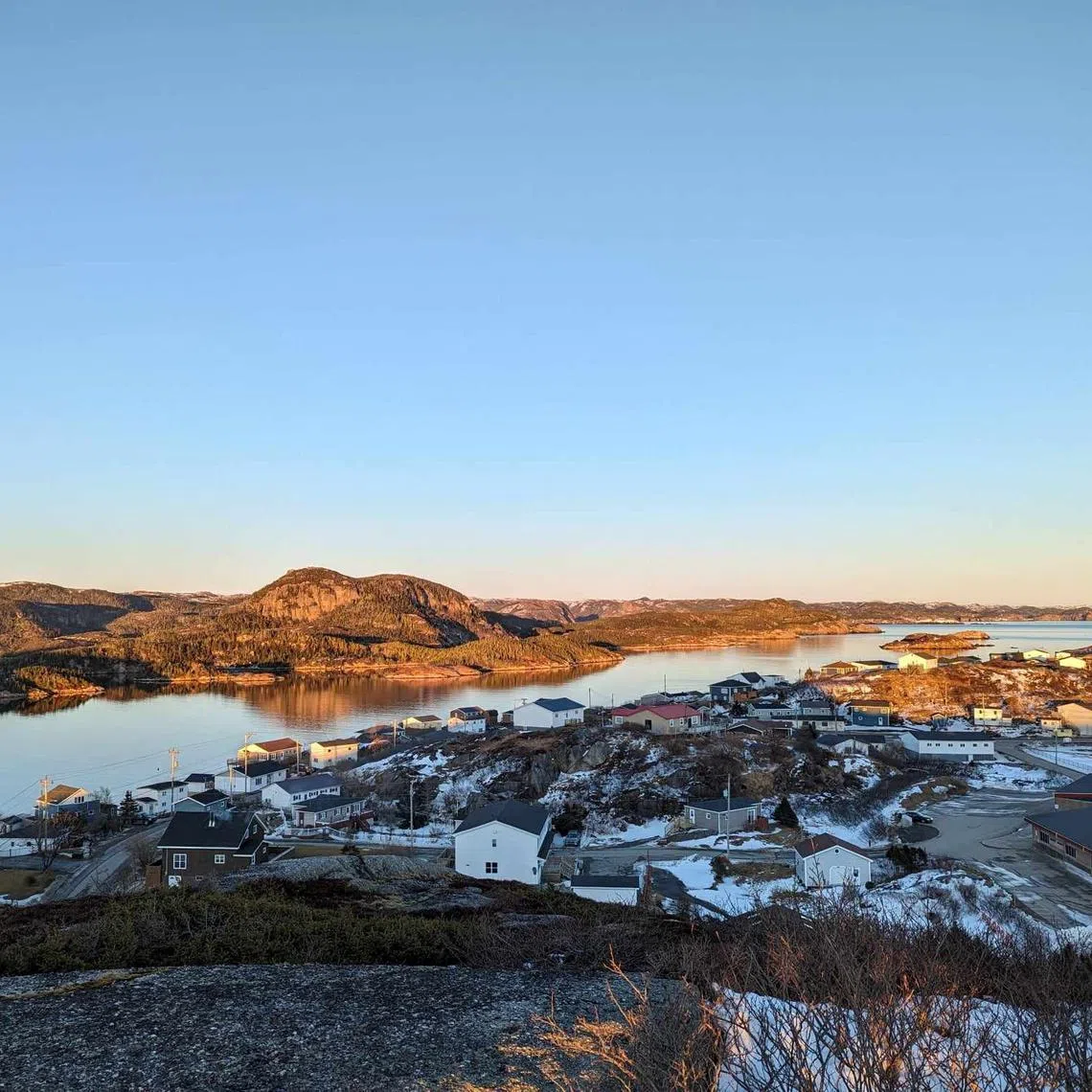 A view from the top of Maiden Tea Hill overlooks the seaside town of Burgeo, with the small Eclipse Island, named by Royal Navy explorer Captain James Cook in 1766, at top right in Newfoundland, Canada February 7, 2024.  Melissa Mills/Handout via REUTERS.