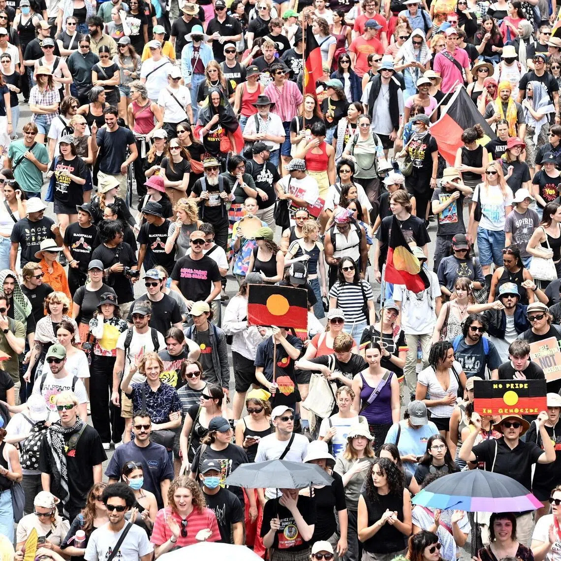 People take part in the Invasion Day protest march through Sydney during Australia Day 2026 celebrations.