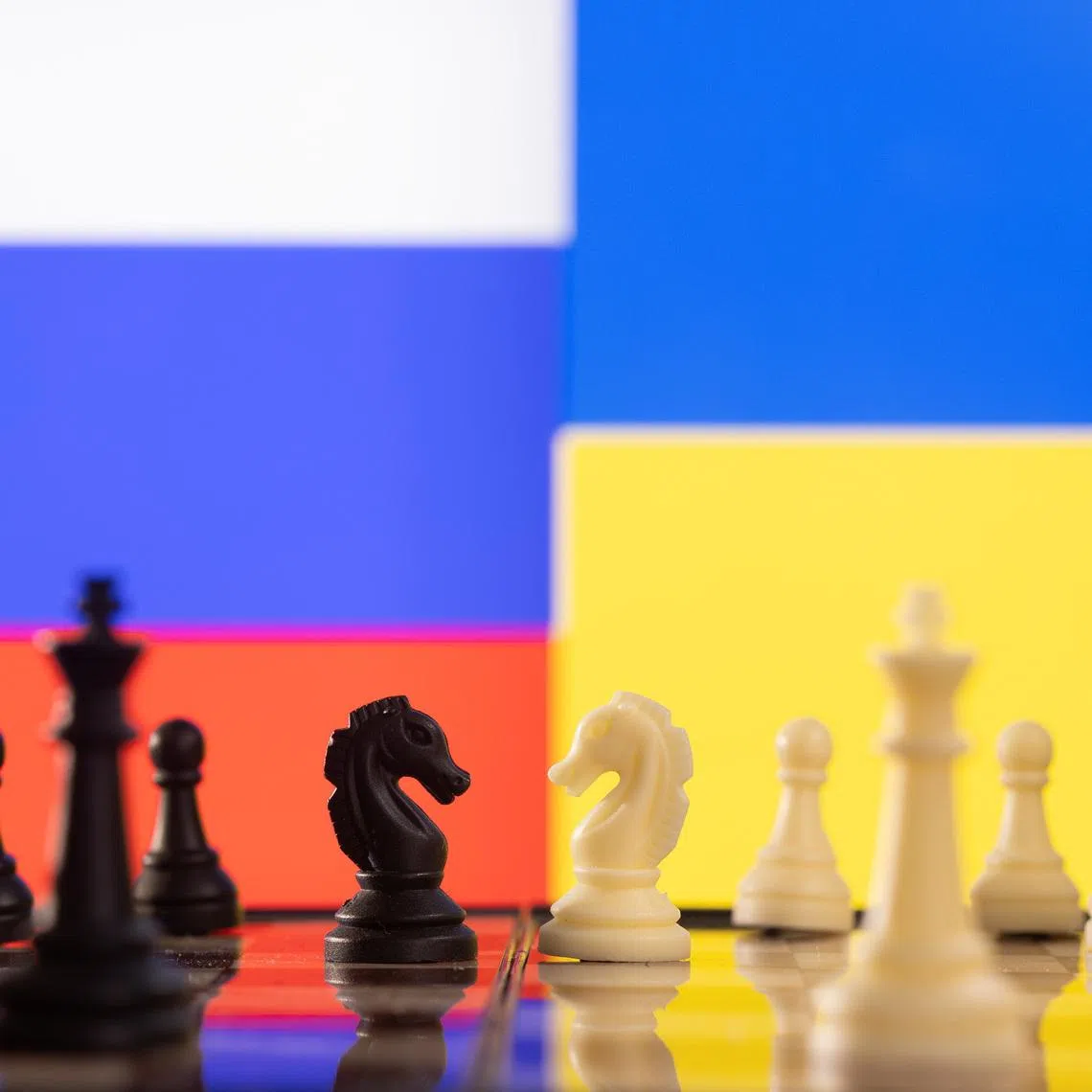 Chess pieces are seen in front of displayed Russia and Ukraine's flags in this illustration taken January 25, 2022. REUTERS/Dado Ruvic/Illustration