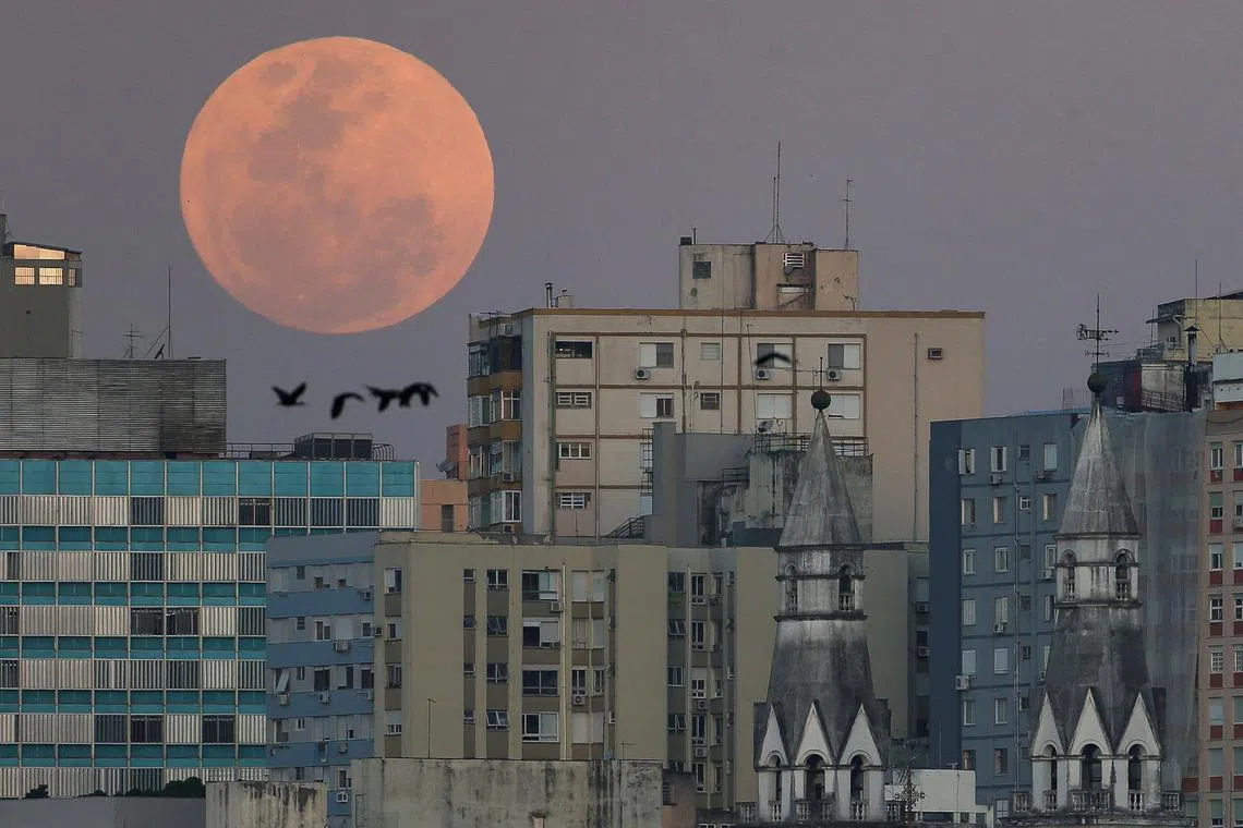 A view showing a full moon known as the 'Blue Moon' over the city of Porto Alegres, Rio Grande do Sul state, Brazil, on Aug 30, 2023.