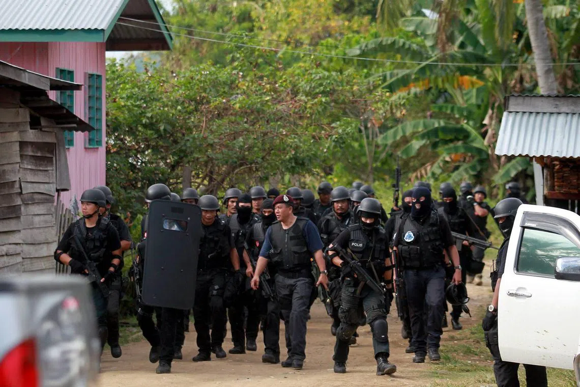 Malaysian special police forces moving out after an operation around Kampung Perigi to search for militants in Semporna, Sabah. Thirty-three people have been detained in Semporna for alleged links to the militants. The militants comprise more than 150 Philippine gunmen loyal to Manila-based, self-styled Sulu Sultan Jamalul Kiram III. They invaded Tanduo on 9 February 2013 to “reclaim” Sabah, a state they insist belonged to the sultanate centuries ago.