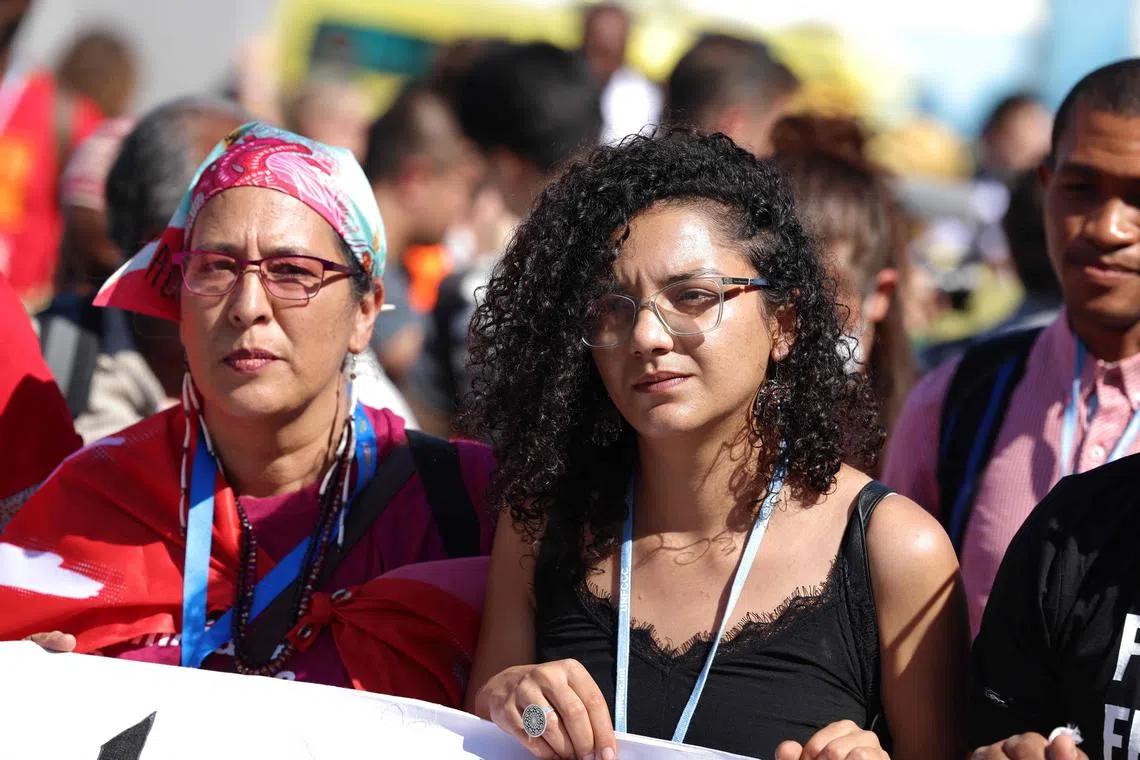 Sanaa Seif (right), sister of jailed hunger-striker activist Alaa Abdel Fattah, was heckled by pro-government attendees.