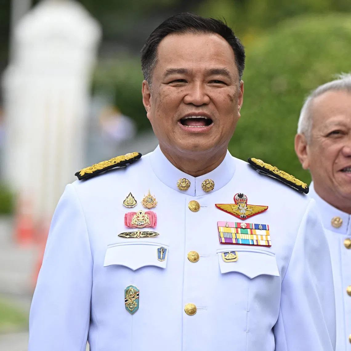 (FILES) Thailand's Deputy Prime Minister, Interior Minister and Bhumjaithai Party leader Anutin Charnvirakul (L) and incoming labour minister and Bhumjaithai Party member Phiphat Ratchakitprakarn (R) arrive at Government House in Bangkok on September 6, 2024, ahead of the new cabinet's royal oath-taking ceremony. Thai Prime Minister Paetongtarn Shinawatra faced mounting calls to resign on June 19, 2025 after a leaked phone call she had with former Cambodian leader Hun Sen provoked widespread anger and a key coalition partner to quit. Growing tensions within the coalition erupted into open warfare in the past week as Shinawatra's Pheu Thai party tried to take the interior minister job away from Bhumjaithai leader Anutin Charnvirakul. (Photo by Lillian SUWANRUMPHA / AFP)