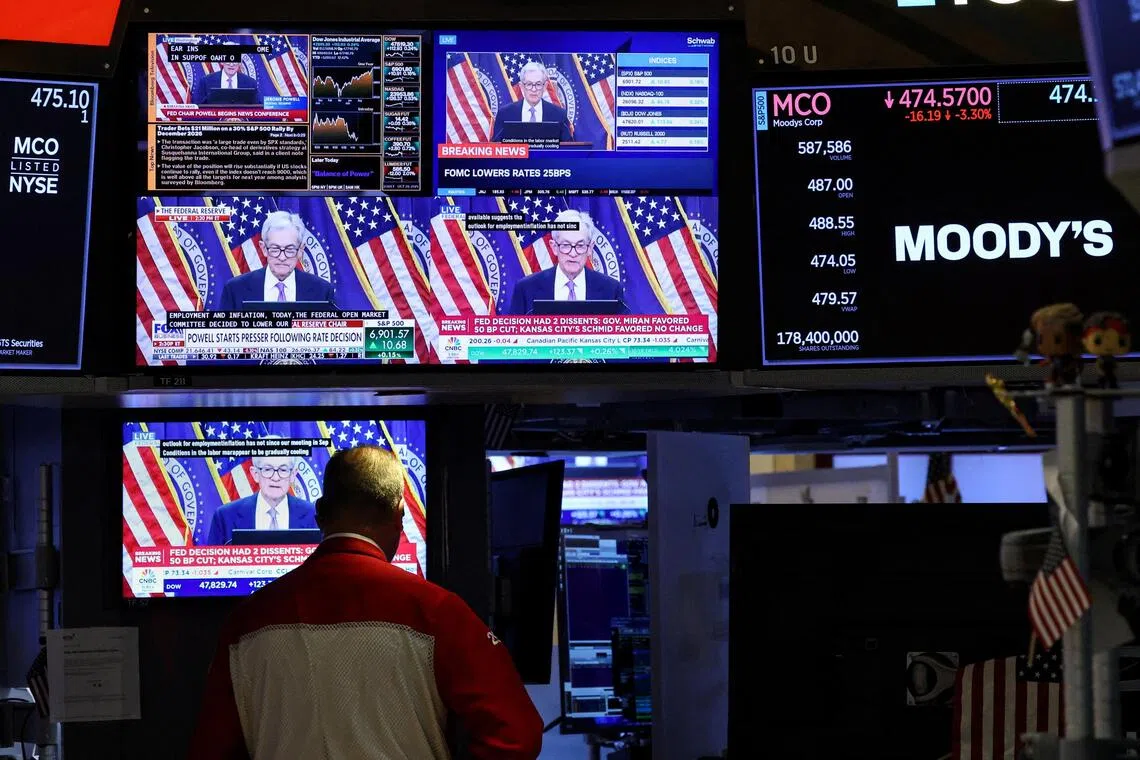 Screens broadcast a news conference by US Federal Reserve Chair Jerome Powell on the floor of the New York Stock Exchange.