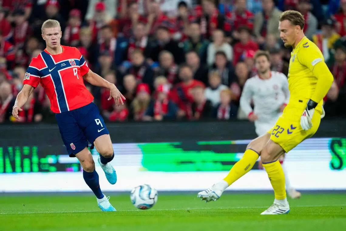 Norway’s Erling Haaland (left) in action against Denmark, in Oslo on Sept 24. He took his tally for the national team to 64 goals in 56 appearances - eclipsing Zlatan Ibrahimovic’s 62 goals in 122 matches for Sweden.