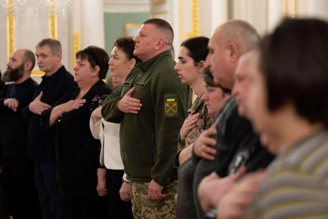 Former Commander in Chief of the Ukrainian Armed Forces Valerii Zaluzhnyi sings a national anthem during an award ceremony, amid Russia's attack on Ukraine, in Kyiv, Ukraine February 9, 2024. Ukrainian Presidential Press Service/Handout via REUTERS