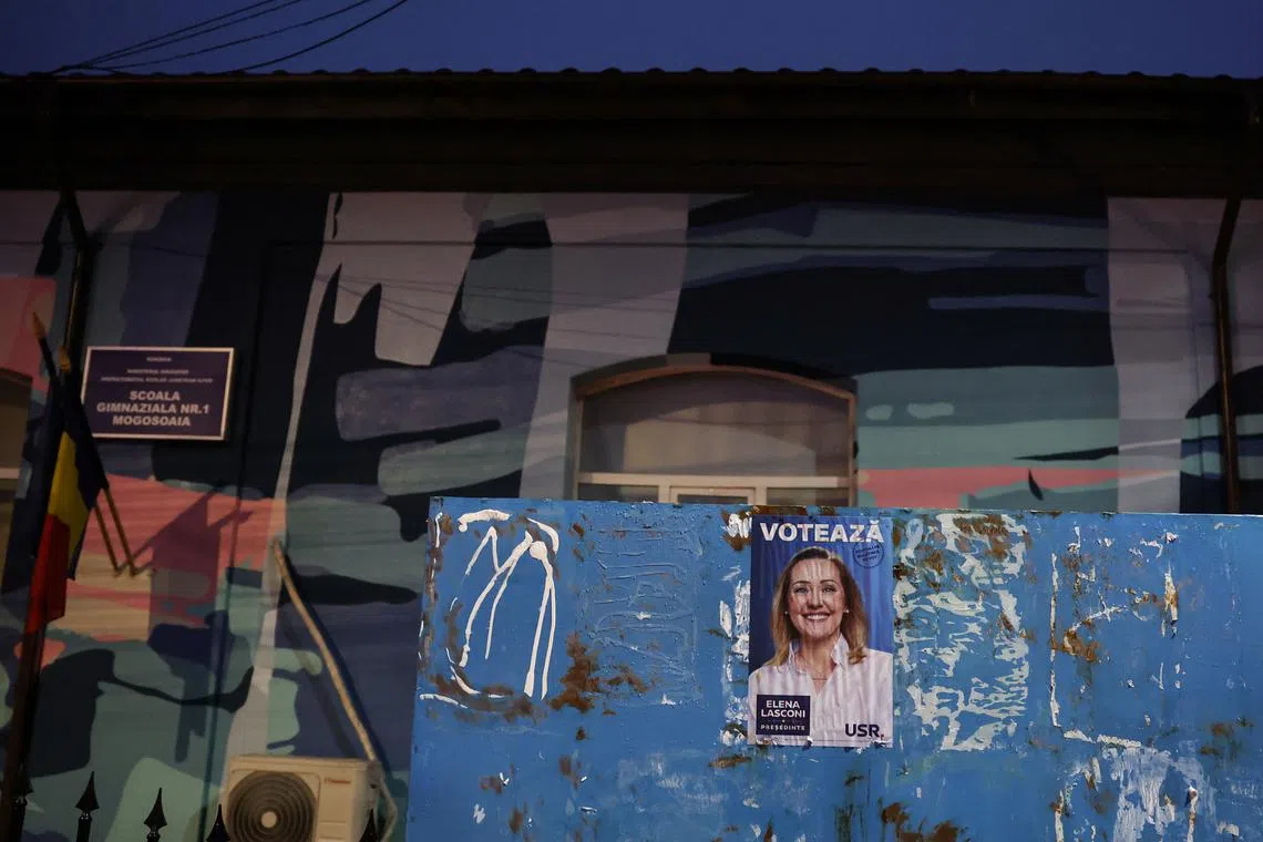 A pre-election poster of Leader of center-right opposition Save Romania Union (USR) Elena Lasconi, is seen outside independent far-right presidential candidate Calin Georgescu voting station in Mogosoaia, Romania, December 8, 2024.  REUTERS/Louisa Gouliamaki