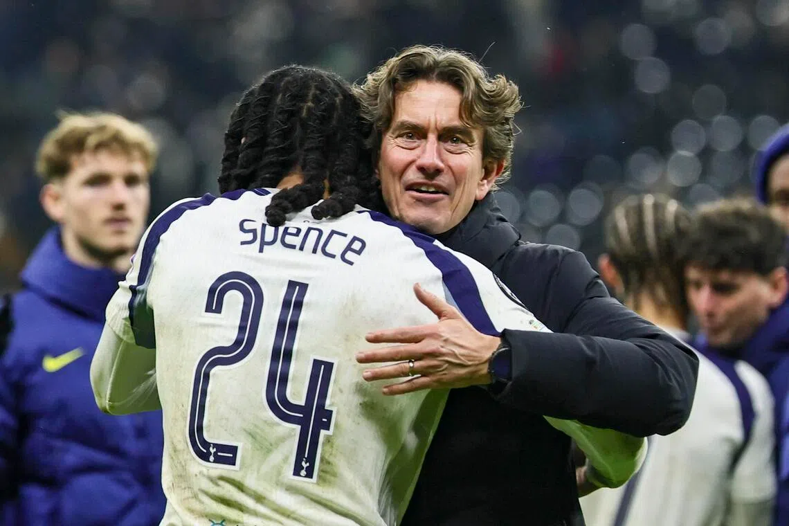 Tottenham manager Thomas Frank and Djed Spence hug after winning the Champions League match against Eintracht Frankfurt.