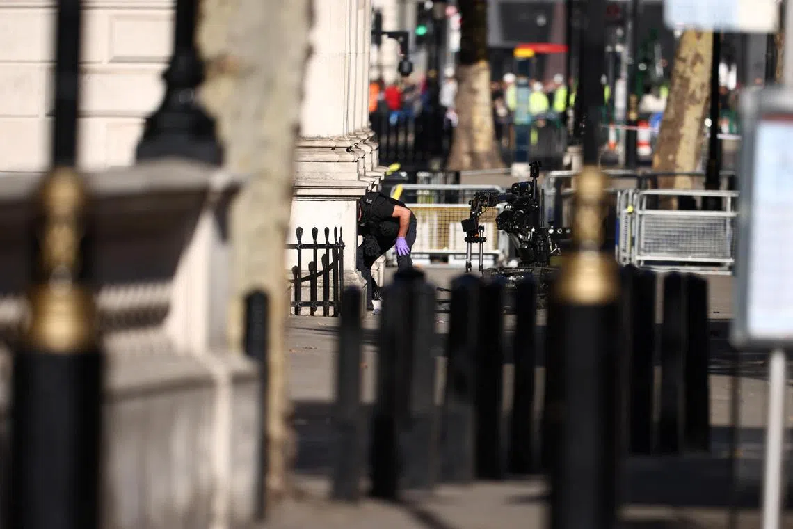 A member of London’s police bomb disposal unit works with a robot at his side in London. San Francisco is taking this to the next level with robots capable of delivering lethal force.