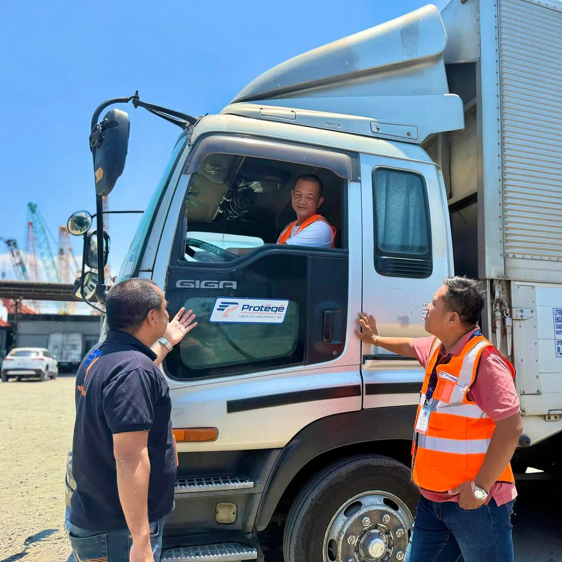 (From left) Mr Omar Tigno, administrative and human resources head at Protege Logistics Philippines Inc, with truck drivers Joseph Gayoso and Marcelo Nablo Jr. at the company's garage in Cabuyao, the Philippines, on April 10.